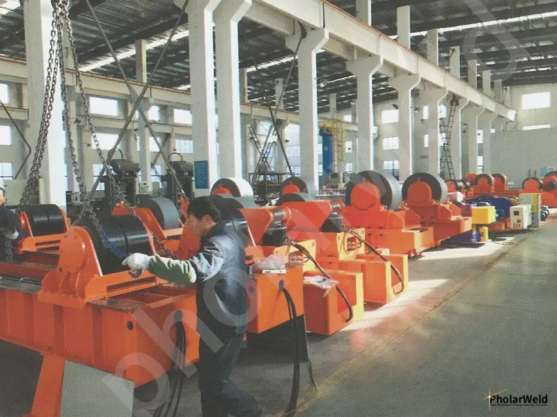 How do welding rollers drive the workpiece rotation?
