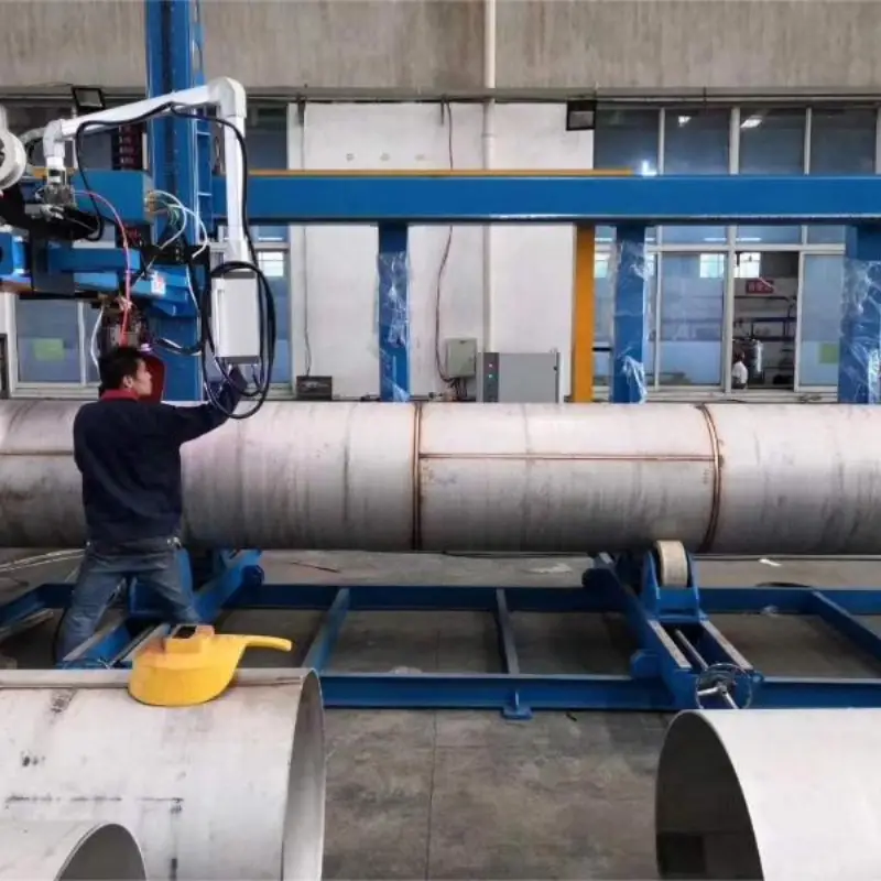 Workers are using a steel tank automatic Welding machine PholarWeld